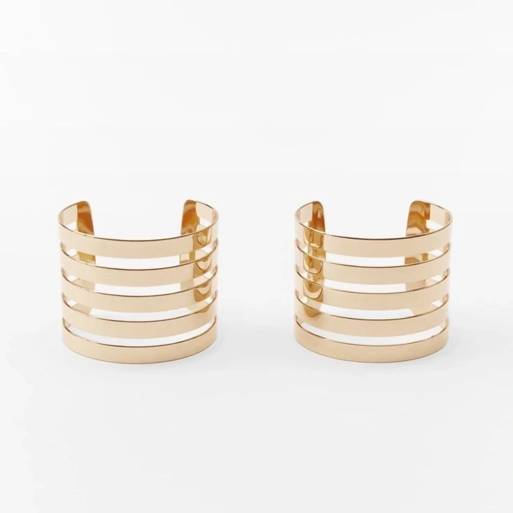 NWT. Zara Golden Pack of Two Metal Rigid Striped Armbands.